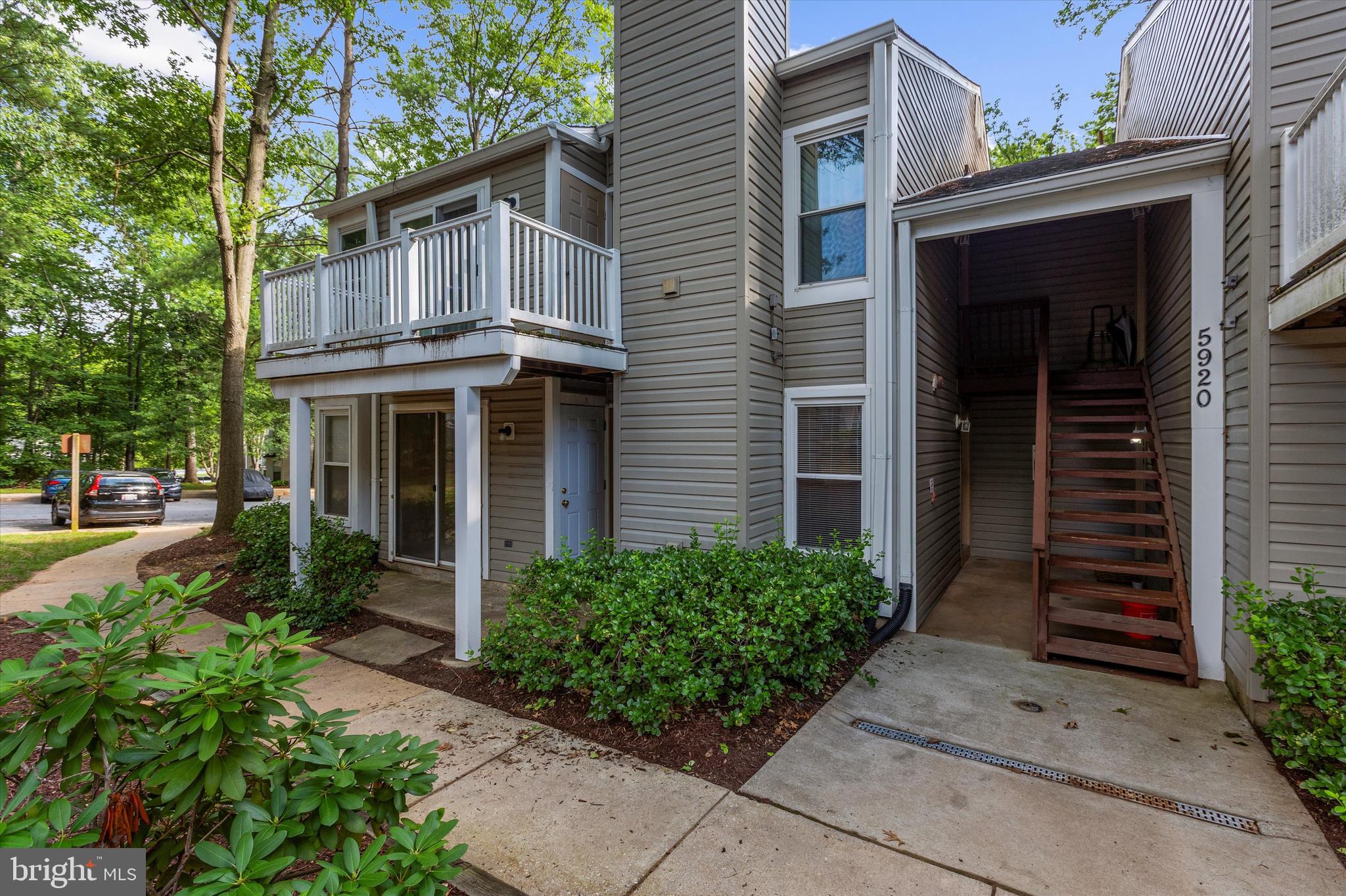 5920 Watch Chain Way, Unit 5102 Columbia, MD 21044 - Photo 4 of 29 a view of a house with brick walls plants and large tree