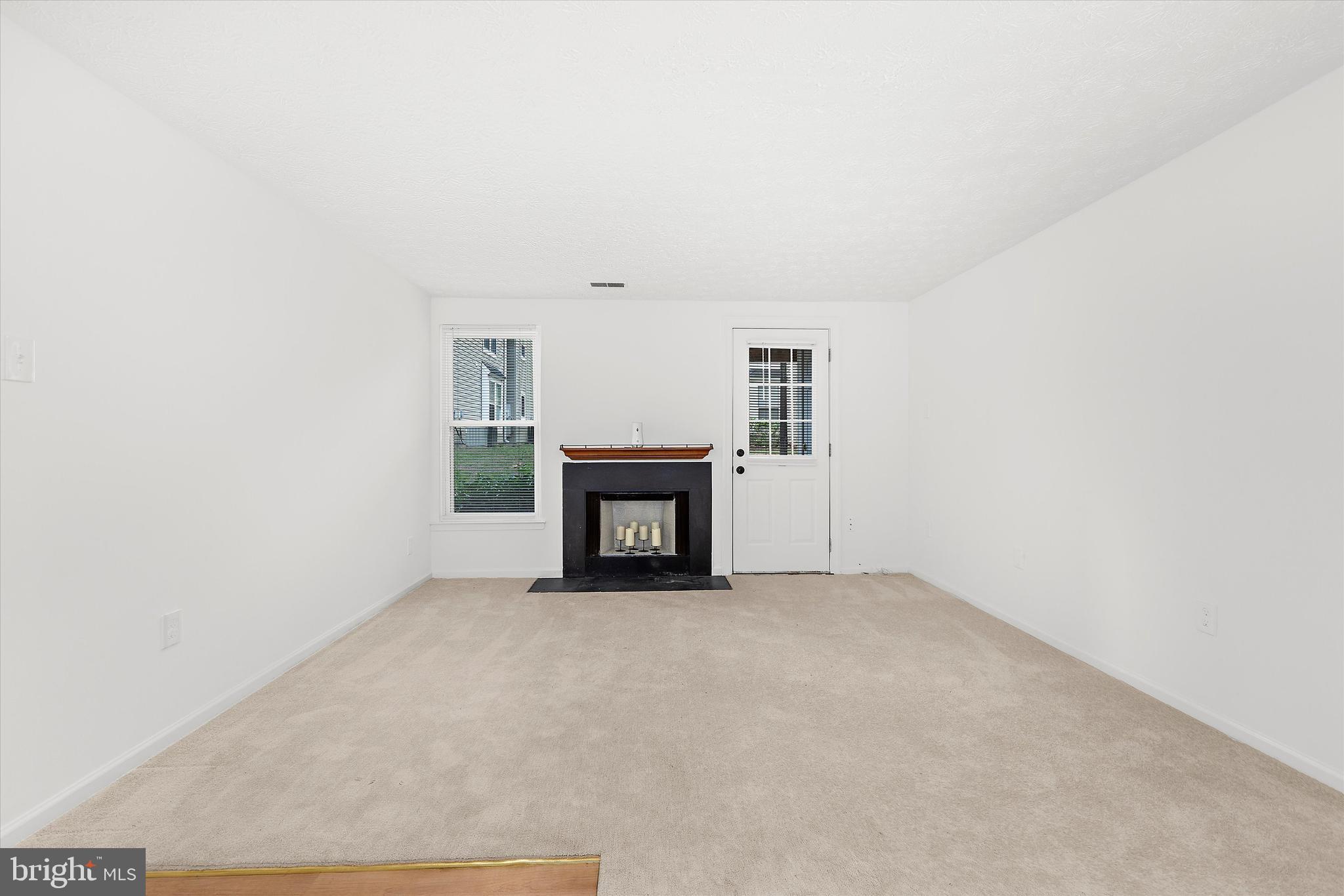 5920 Watch Chain Way, Unit 5102 Columbia, MD 21044 - Photo 9 of 29 a view of an empty room with a fireplace and a window