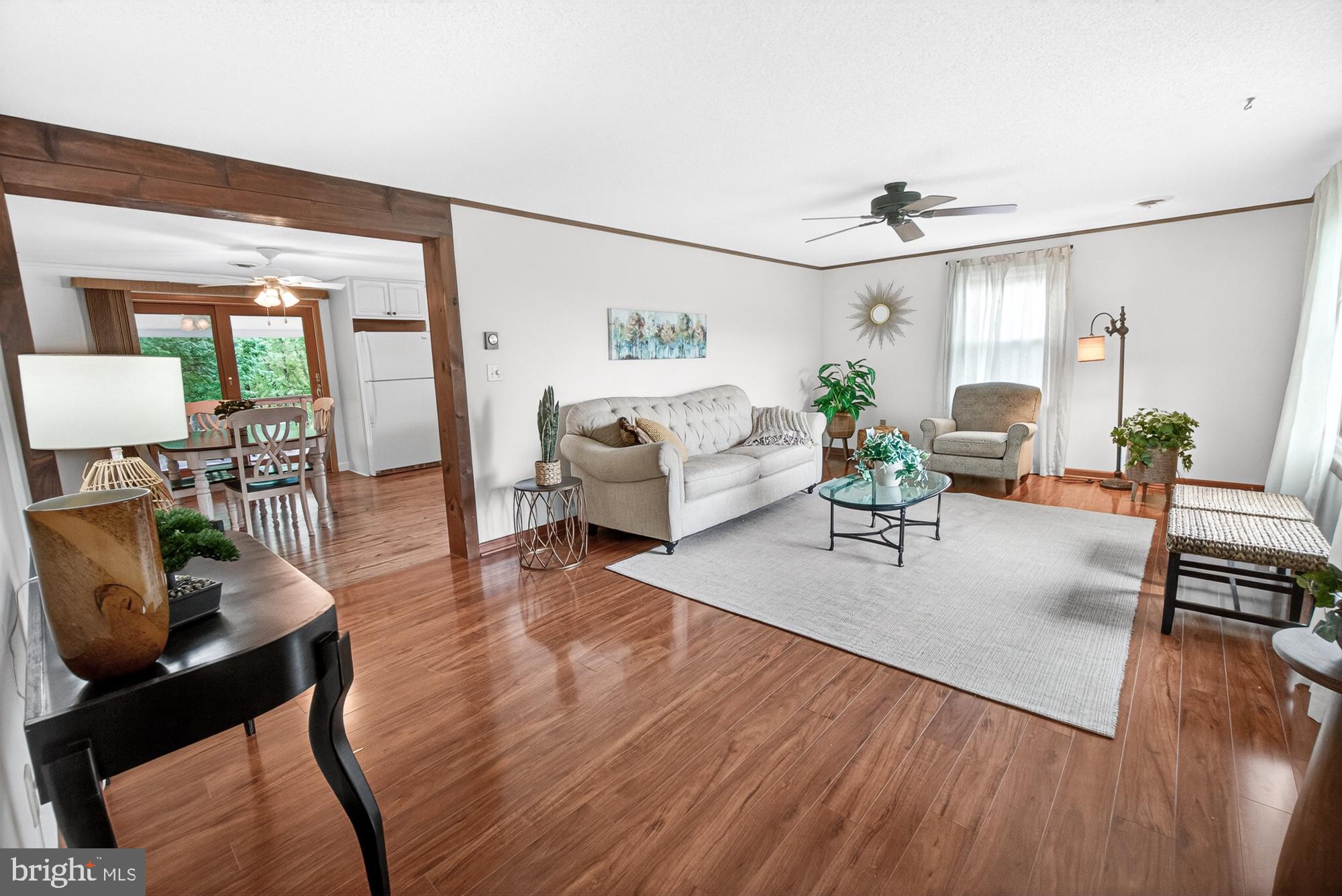 5601 Woodville Road Mount Airy, MD 21771 - Photo 21 of 54 a living room with furniture and a wooden floor