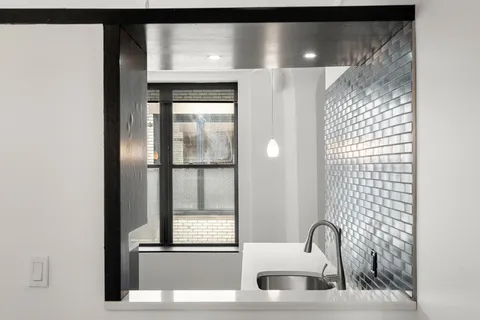 a bathroom with a sink and mirror