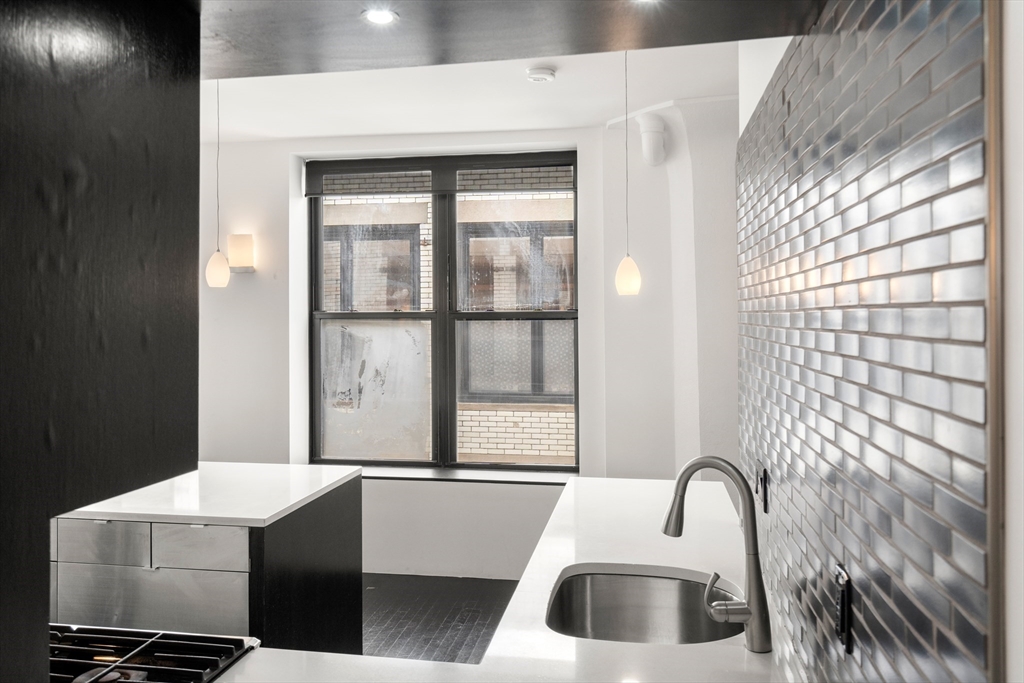 453 Washington Street, Unit 11B Boston, MA 02111 - Photo 13 of 30 a bathroom with a sink toilet and shower