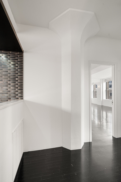 453 Washington Street, Unit 11B Boston, MA 02111 - Photo 14 of 30 a view of an empty room with wooden floor and a window