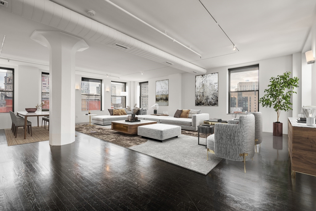 453 Washington Street, Unit 11B Boston, MA 02111 - Photo 2 of 30 a living room with furniture and wooden floor