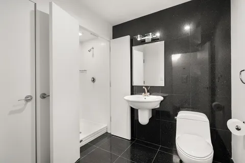 a bathroom with a sink toilet and a mirror