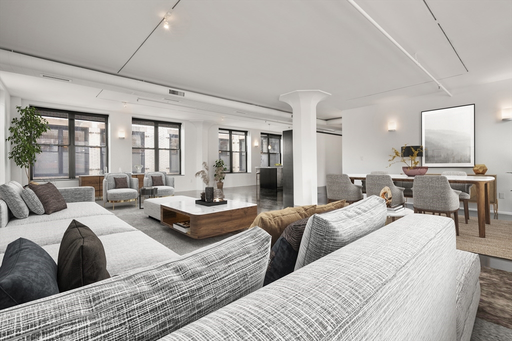 453 Washington Street, Unit 11B Boston, MA 02111 - Photo 3 of 30 a large bedroom with three beds and large windows