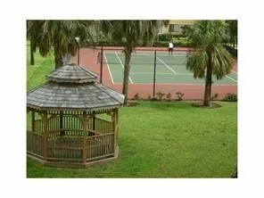 a view of a park with iron fence