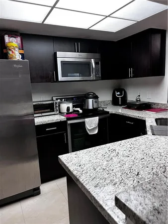 a kitchen with a sink and a stove top oven
