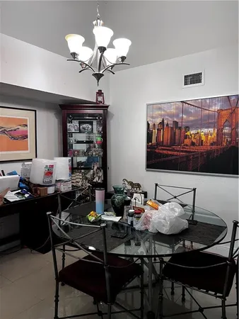 a table room with furniture and chandelier