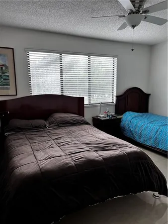 a bedroom with a large bed and a large window