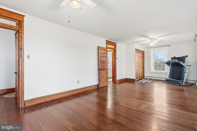 a view of empty room with wooden floor