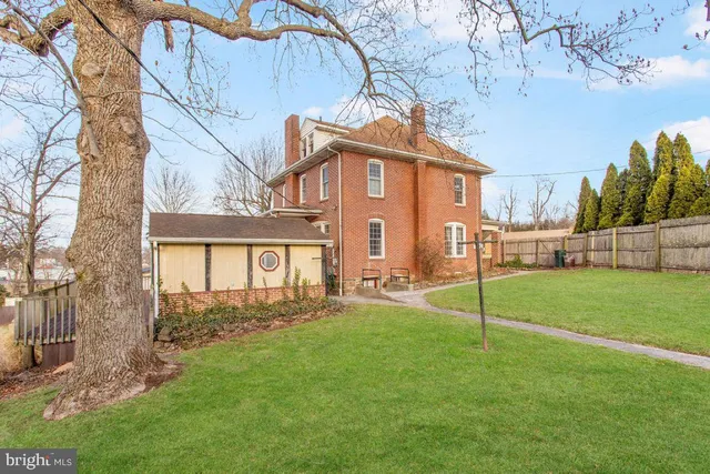 a view of a house with a yard and sitting area