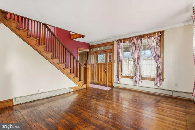 a view of an entryway with wooden floor