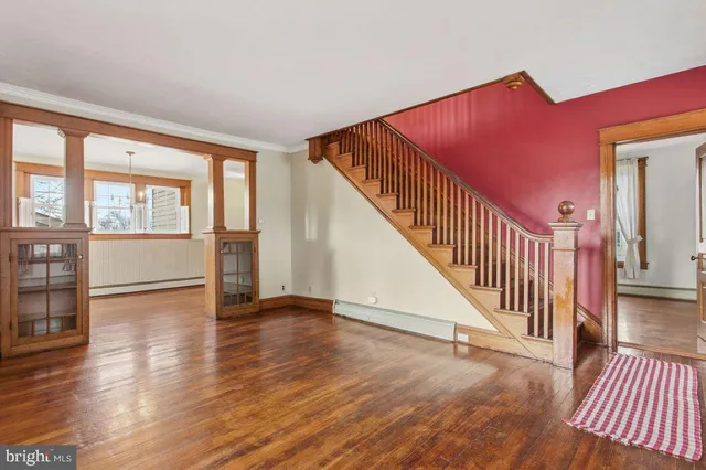 a view of an entryway with wooden floor and door