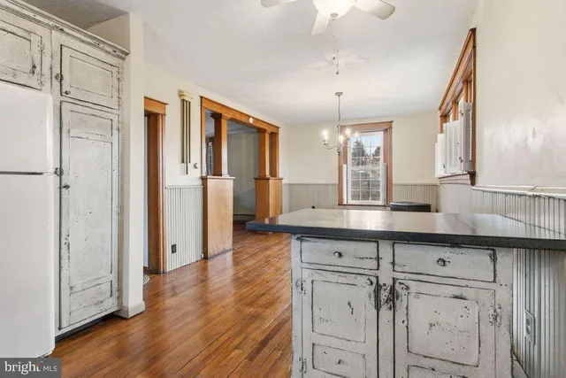 a kitchen with stainless steel appliances a sink cabinets and wooden floor