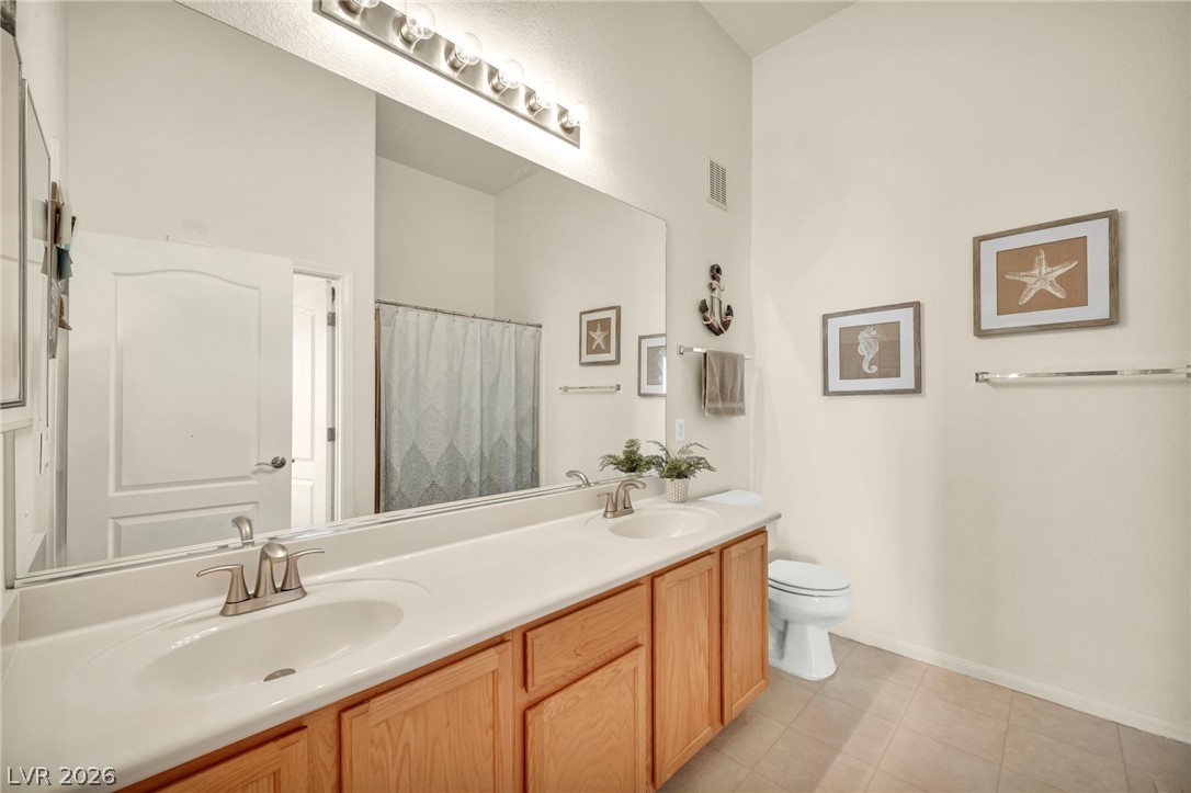 2305 West Horizon Ridge Parkway, Unit 3621 Henderson, NV 89052 - Photo 11 of 23 A well-appointed bathroom offers a double vanity and tile flooring.