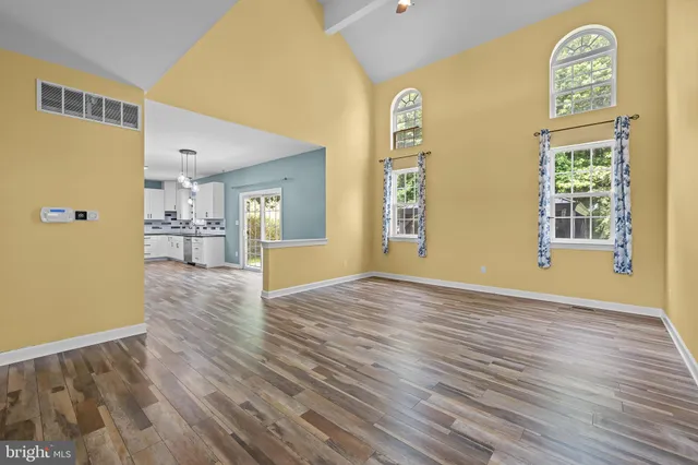 a view of a livingroom with wooden floor and a window