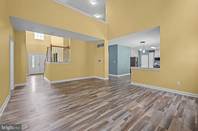 a view of a living room with wooden floor and a large window