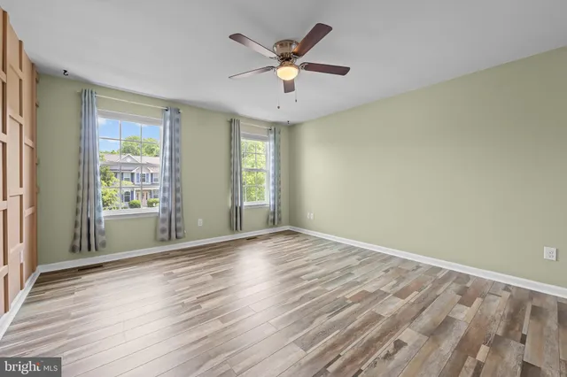 wooden floor in an empty room with a window