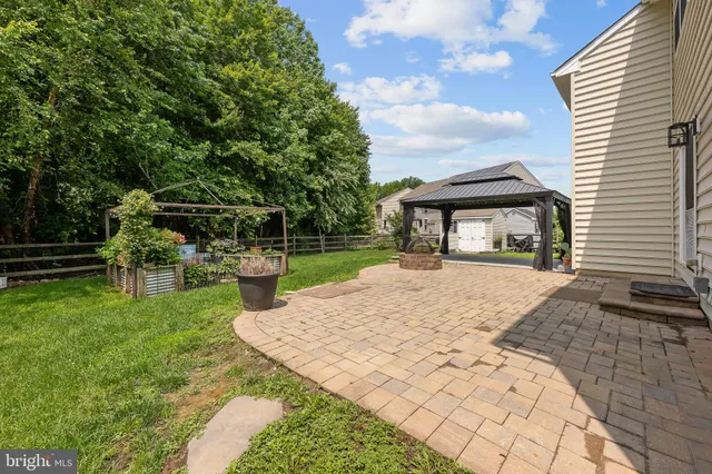 a view of house with backyard porch and garden