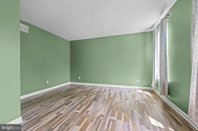 a view of a room with wooden floor