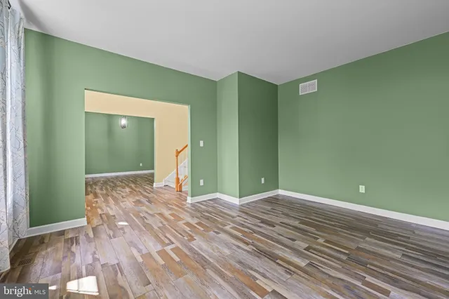 a bedroom with a large bed and green walls