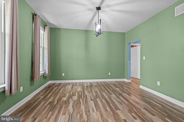 a view of a room with a ceiling fan and window