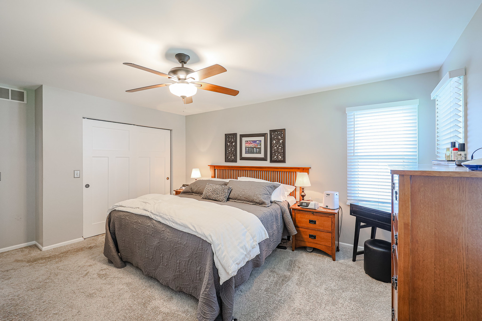 135 Cinderford Drive Oswego, IL 60543 - Photo 16 of 32 a bedroom with a bed and a chandelier