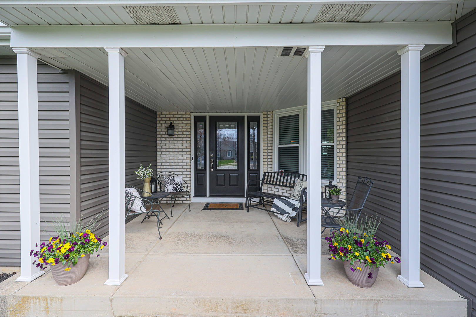 135 Cinderford Drive Oswego, IL 60543 - Photo 2 of 32 a front view of a house with outdoor seating