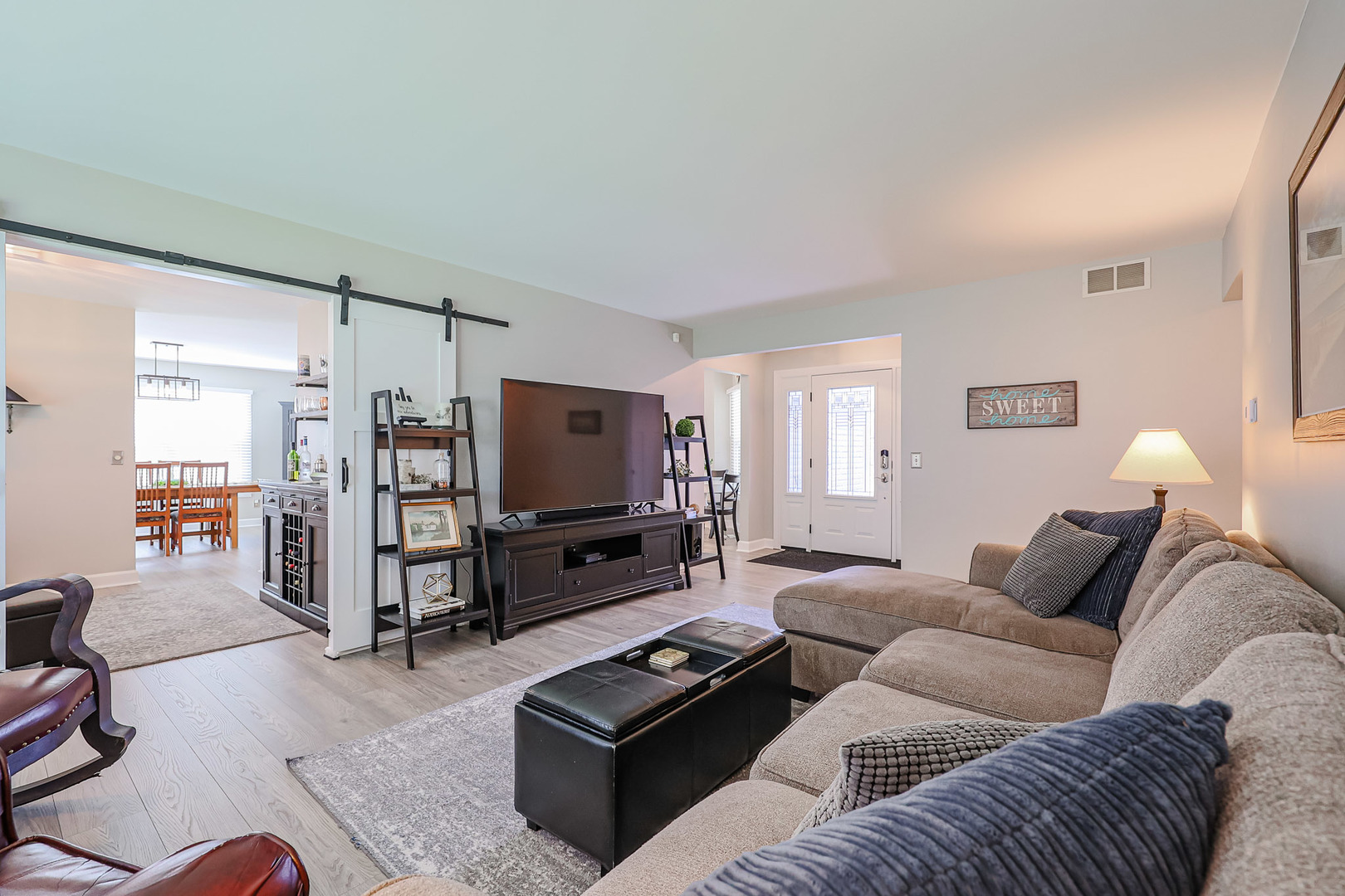 135 Cinderford Drive Oswego, IL 60543 - Photo 3 of 32 a living room with furniture and a flat screen tv
