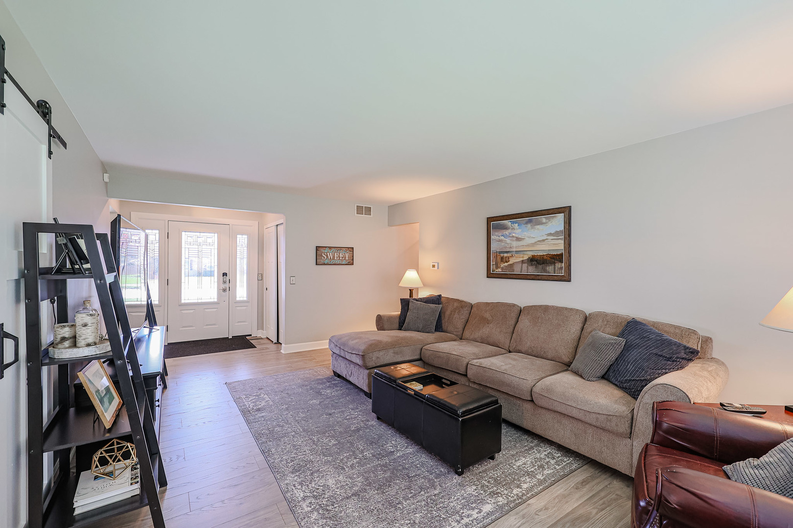 135 Cinderford Drive Oswego, IL 60543 - Photo 4 of 32 a living room with furniture or couch and a flat screen tv