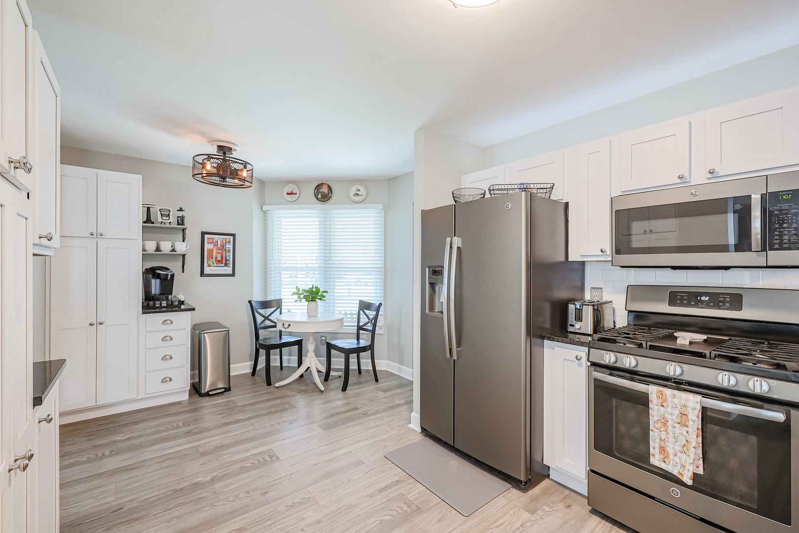135 Cinderford Drive Oswego, IL 60543 - Photo 8 of 32 a kitchen with stainless steel appliances a refrigerator stove and microwave