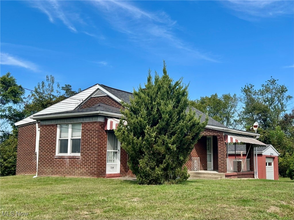 164 Locust Lane Follansbee, WV 26037 - Photo 18 of 19 View of front of home featuring a front yard, brick siding, and a porch