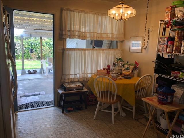 a outdoor dining room with furniture and a chandelier