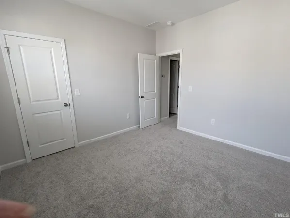 a view of an empty room and closet area