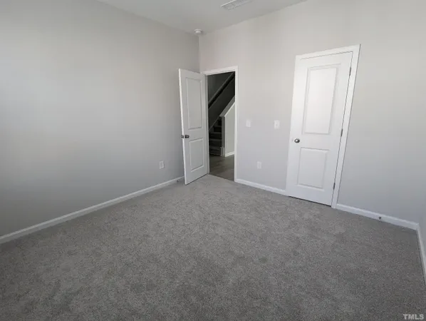 a view of an empty room and closet