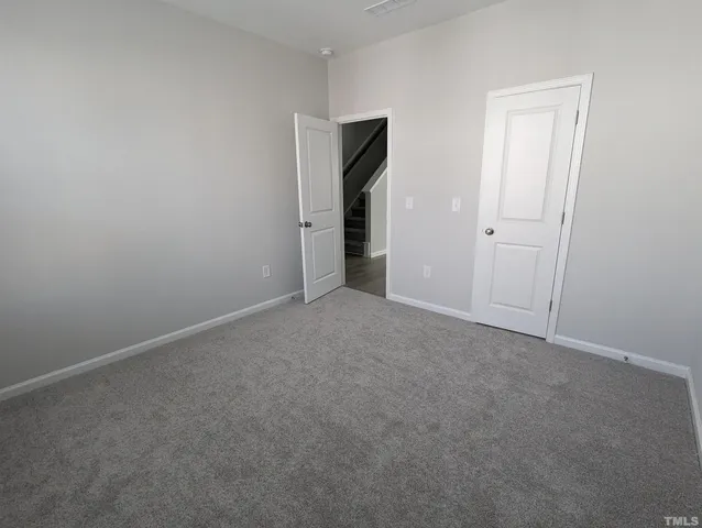 a view of an empty room and closet