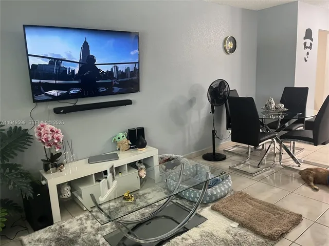 a living room with furniture and flowers