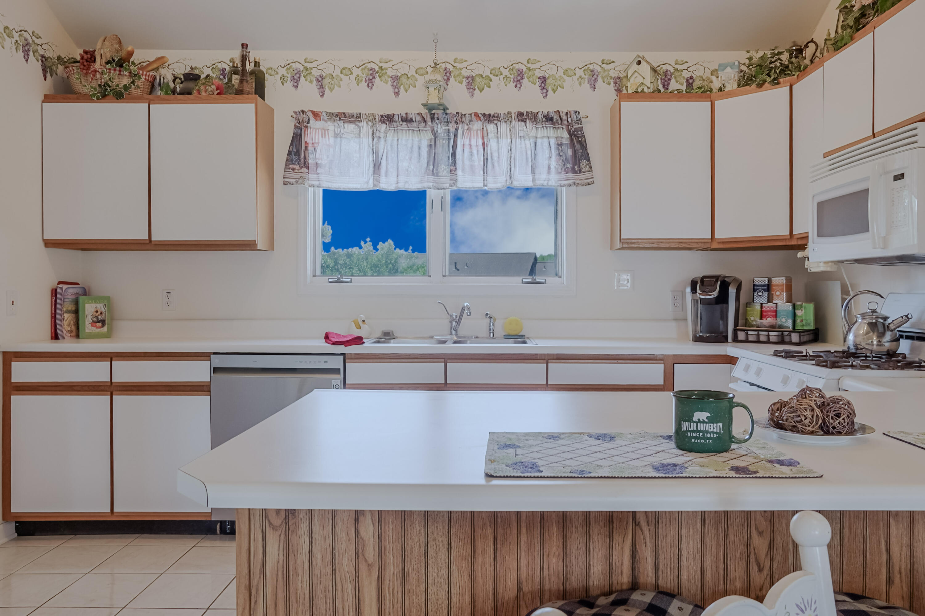 5065 Spinnaker Lane, Unit D Crown Point, IN 46307 - Photo 14 of 42 a kitchen with stainless steel appliances white cabinets a sink and a stove