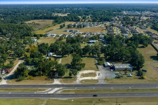 an aerial view of residential houses with outdoor space and river