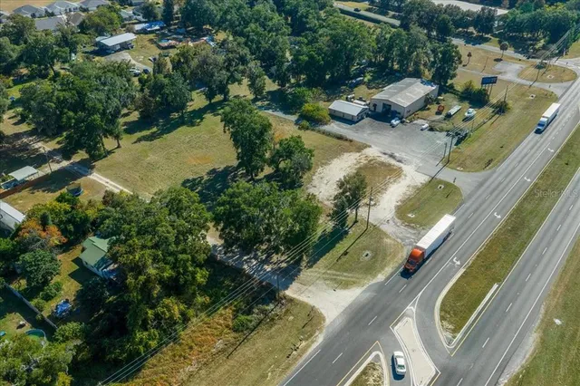an aerial view of residential houses with outdoor space and swimming pool