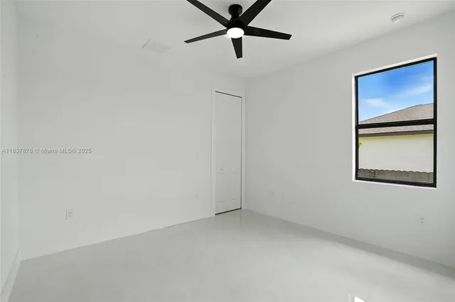 a view of room with window and ceiling fan