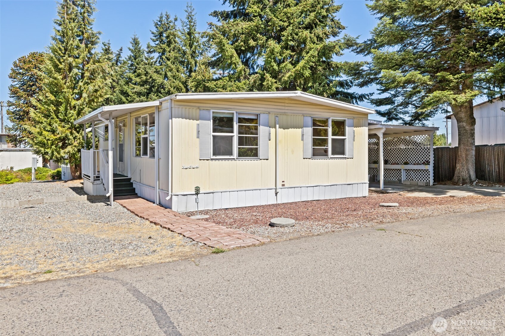 921 South 3rd Avenue, Unit 20 Sequim, WA 98382 - Photo 12 of 37 a front view of a house with a yard and garage