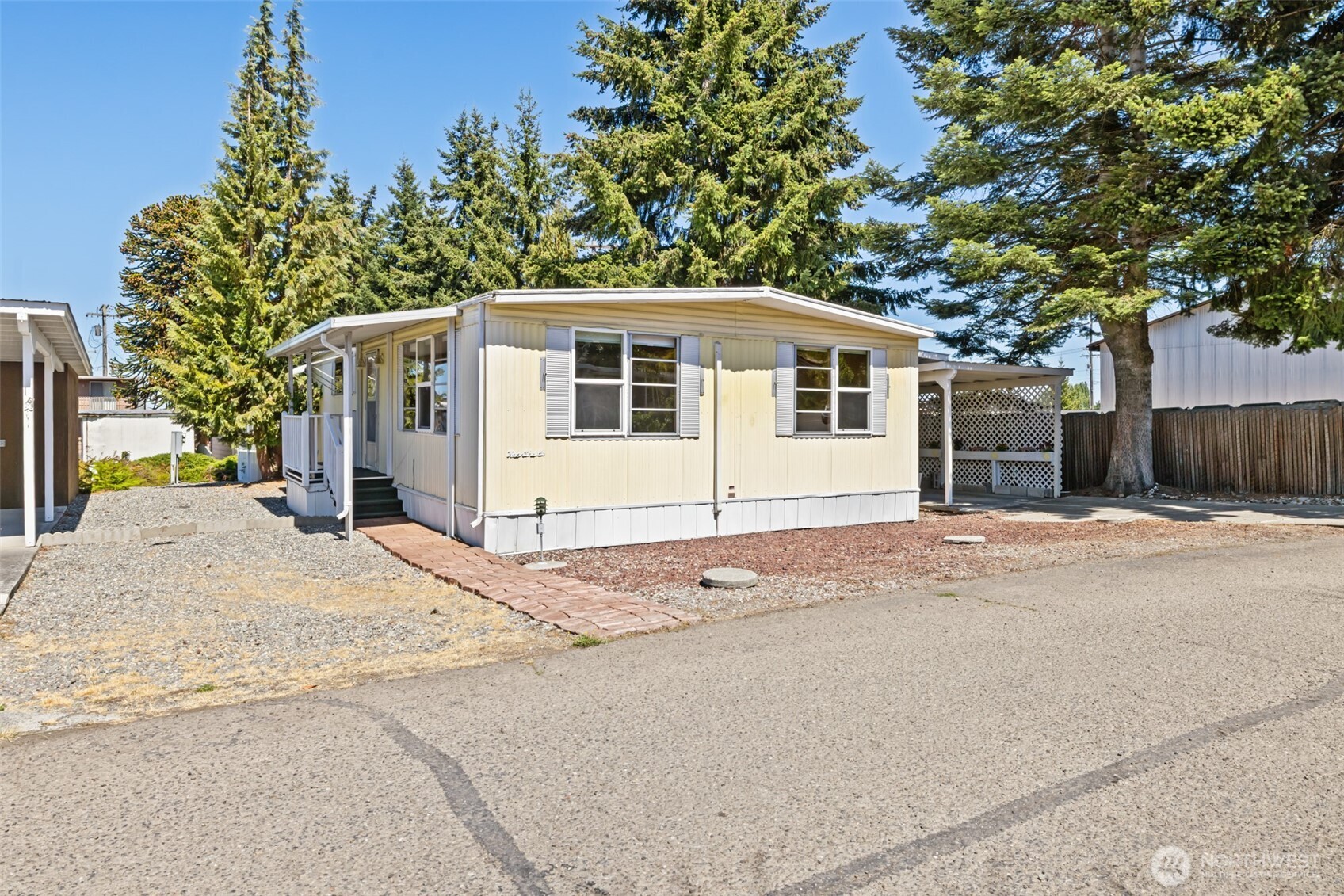 921 South 3rd Avenue, Unit 20 Sequim, WA 98382 - Photo 13 of 37 a front view of a house with a yard and garage