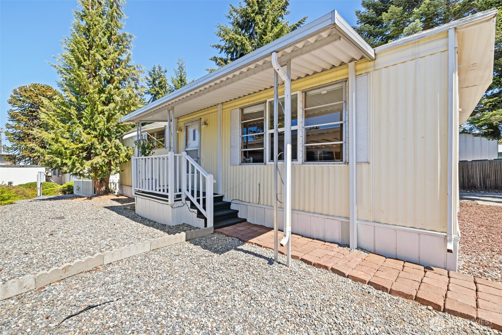 921 South 3rd Avenue, Unit 20 Sequim, WA 98382 - Photo 14 of 37 a view of a house with a yard and wooden fence