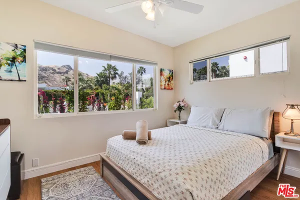 a bathroom with a sink a toilet a mirror and shower