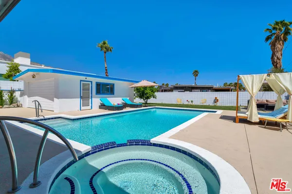 a view of a swimming pool with a lounge chairs