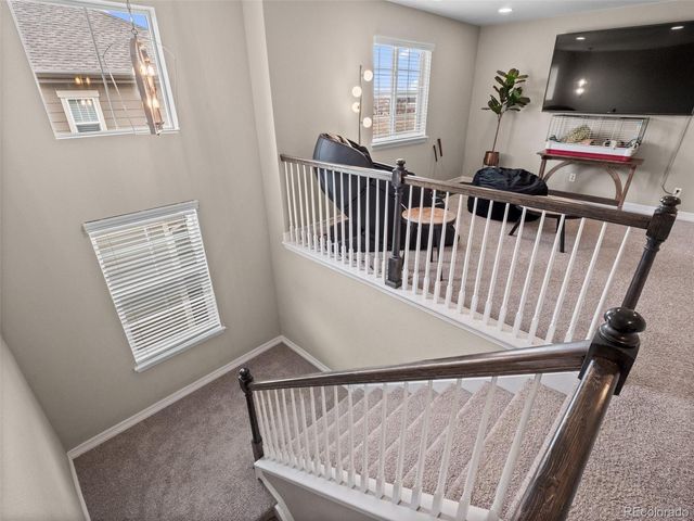 a view of hallway with furniture and a flat screen tv