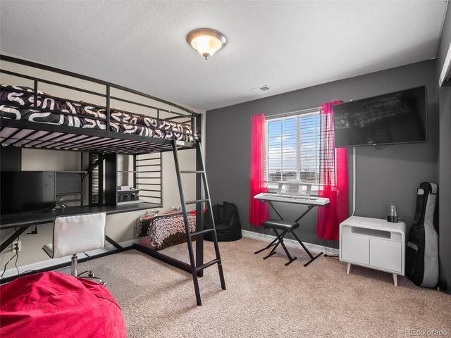 a living room with furniture a flat screen tv and a large window