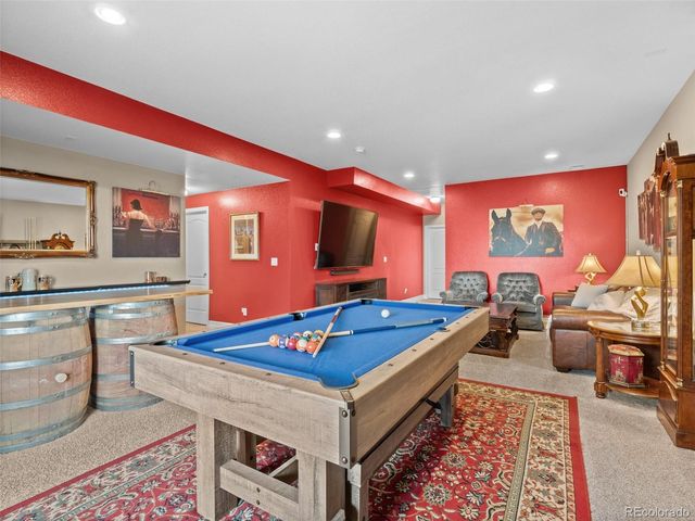 a living room with table tennis pool table and a couch