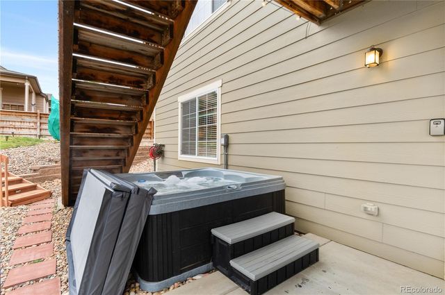 a view of backyard with deck and outdoor seating
